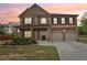 Charming two-story brick home with a well-manicured front yard, offering curb appeal and a welcoming entrance at 811 Holly Mist Ct, Loganville, GA 30052