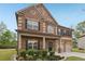 Attractive brick home with a covered porch, black shutters, and a well-maintained front yard at 811 Holly Mist Ct, Loganville, GA 30052