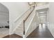 Elegant foyer featuring hardwood floors, white staircase with carpeted steps, and wainscoting at 811 Holly Mist Ct, Loganville, GA 30052