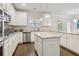 Bright kitchen featuring white cabinets, stainless appliances, granite counters, and an island at 811 Holly Mist Ct, Loganville, GA 30052
