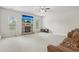 Bright living room with a stone fireplace, neutral carpet, and large windows for natural light at 811 Holly Mist Ct, Loganville, GA 30052