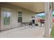 Covered patio with neutral colors featuring grilling area and door to the house at 811 Holly Mist Ct, Loganville, GA 30052