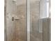 Close up of the shower with attractive tile work and bronze fixtures at 811 Holly Mist Ct, Loganville, GA 30052