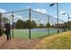Well-maintained tennis court surrounded by a fence, offering a recreational space for residents to enjoy at 811 Holly Mist Ct, Loganville, GA 30052