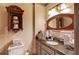 Cozy bathroom featuring a granite countertop, cherry wood mirror, and convenient toilet paper storage at 2740 Drayton Hall Dr, Buford, GA 30519