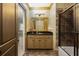Elegant bathroom with a granite countertop vanity, a large gold framed mirror, and a glass-enclosed shower at 2740 Drayton Hall Dr, Buford, GA 30519