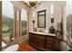 Unique bathroom featuring an elegant vanity, decorative wall art, and a vintage-style chandelier at 2740 Drayton Hall Dr, Buford, GA 30519