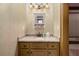 Stylish bathroom vanity area with decorative wallpaper, granite countertop, and neutral light fixture at 2740 Drayton Hall Dr, Buford, GA 30519
