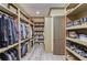 Spacious walk-in closet with built-in storage, hanging racks, and shoe shelves at 2740 Drayton Hall Dr, Buford, GA 30519