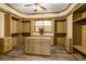 Large walk-in closet featuring built-in shelving, drawers, and an island with a granite countertop at 2740 Drayton Hall Dr, Buford, GA 30519