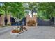 Elegant community entrance with brick columns, wrought iron gates, and lush landscaping at 2740 Drayton Hall Dr, Buford, GA 30519