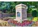 Charming community entrance adorned with colorful flowers, greenery, and the stone Drayton Hall sign at 2740 Drayton Hall Dr, Buford, GA 30519