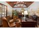Elegant home office with wood paneled walls, custom mural, fireplace, and hardwood floors at 2740 Drayton Hall Dr, Buford, GA 30519