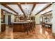 Spacious kitchen features granite counters, exposed beams, hardwood flooring, and dining area at 2740 Drayton Hall Dr, Buford, GA 30519
