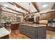 Expansive kitchen features a large island, custom cabinetry, wood beams, and stainless steel appliances at 2740 Drayton Hall Dr, Buford, GA 30519