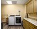 Efficient laundry room features modern washer and dryer, with ample cabinet space for storage at 2740 Drayton Hall Dr, Buford, GA 30519