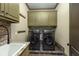 Well-lit laundry room with slate tile floor, modern washer/dryer, and ample cabinet space at 2740 Drayton Hall Dr, Buford, GA 30519