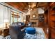 Cozy living room with stone fireplace, coffered ceiling, hardwood floors, and custom millwork at 2740 Drayton Hall Dr, Buford, GA 30519