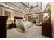 Spacious main bedroom with tray ceilings, fireplace, traditional furnishings, and patterned carpeting at 2740 Drayton Hall Dr, Buford, GA 30519