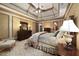 Spacious main bedroom with tray ceilings, traditional furnishings, patterned carpeting, and fireplace at 2740 Drayton Hall Dr, Buford, GA 30519