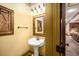 Quaint powder room featuring stylish mirror, vanity and fixtures, conveniently located near living area at 2740 Drayton Hall Dr, Buford, GA 30519
