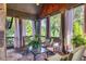 Relaxing sunroom with stone fireplace, floor, and walls, and views of the surrounding property at 2740 Drayton Hall Dr, Buford, GA 30519