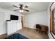 Bedroom featuring a ceiling fan, a television and a desk near a bright window at 3444 Wood Acres Blvd, Duluth, GA 30096