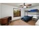 Bedroom features a bunk bed, ceiling fan and natural light from the window at 3444 Wood Acres Blvd, Duluth, GA 30096