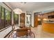 Cozy breakfast nook with a round glass table, four chairs, and bright natural light at 3444 Wood Acres Blvd, Duluth, GA 30096