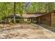 Single story home with stone accents, manicured bushes, and large driveway at 3444 Wood Acres Blvd, Duluth, GA 30096