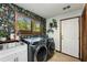 Well-equipped laundry room with modern washer, dryer, and floral wallpaper at 3444 Wood Acres Blvd, Duluth, GA 30096