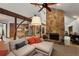 Comfortable living room with stone fireplace, wooden beams and convenient access to the kitchen at 3444 Wood Acres Blvd, Duluth, GA 30096