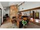 Spacious living room featuring a stone fireplace, wooden beams, and open floor plan at 3444 Wood Acres Blvd, Duluth, GA 30096