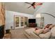 Cozy living room with a stone fireplace, vaulted ceiling, and French doors leading to the backyard at 3444 Wood Acres Blvd, Duluth, GA 30096