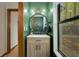 Stylish powder room featuring a modern vanity, round mirror, and vibrant green walls at 3444 Wood Acres Blvd, Duluth, GA 30096
