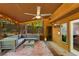 Relaxing sunroom features a ceiling fan, cozy seating and views of backyard at 3444 Wood Acres Blvd, Duluth, GA 30096