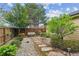 Charming backyard with a wooden swing, stone pathway, and lush landscaping at 4580 Orchard Ridge Ct, Cumming, GA 30028
