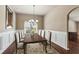 Traditional dining room featuring hardwood floors, elegant chandelier, and wainscoting at 4580 Orchard Ridge Ct, Cumming, GA 30028