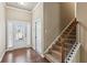 Inviting entryway featuring hardwood floors and a staircase with decorative railings at 4580 Orchard Ridge Ct, Cumming, GA 30028