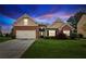 Charming single-Gathering home featuring a brick facade, well-manicured lawn, and an attached two-car garage at dusk at 4580 Orchard Ridge Ct, Cumming, GA 30028