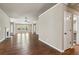 Open-concept living room with hardwood floors and a fireplace at 4580 Orchard Ridge Ct, Cumming, GA 30028