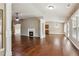 Large living area with fireplace, hardwood floors, and view of dining and kitchen at 4580 Orchard Ridge Ct, Cumming, GA 30028