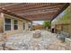 Covered patio area with stone firepit, grill, and pergola at 4580 Orchard Ridge Ct, Cumming, GA 30028