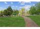 Scenic pond with a gravel path and bench, surrounded by mature trees and greenery at 4580 Orchard Ridge Ct, Cumming, GA 30028
