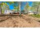 Home's backyard with a wooden deck, surrounded by trees, offering privacy and space for outdoor enjoyment at 56 Windom Dr, Carrollton, GA 30116