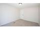 Bright bedroom featuring neutral walls, plush carpet, and simple white door and trim at 56 Windom Dr, Carrollton, GA 30116