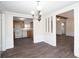 Dining area transitioning into an open kitchen with white appliances and wood cabinets at 56 Windom Dr, Carrollton, GA 30116