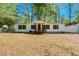 Charming single-story home featuring white siding, dark blue shutters, and a welcoming front porch at 56 Windom Dr, Carrollton, GA 30116