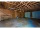 Spacious garage featuring a bare wood frame, concrete floor, and two white doors providing ample storage and work space at 56 Windom Dr, Carrollton, GA 30116