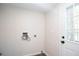 Neutral laundry room features a door to the back yard at 56 Windom Dr, Carrollton, GA 30116